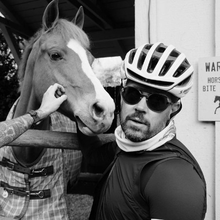 The photo of Colin Maness petting the horse.
